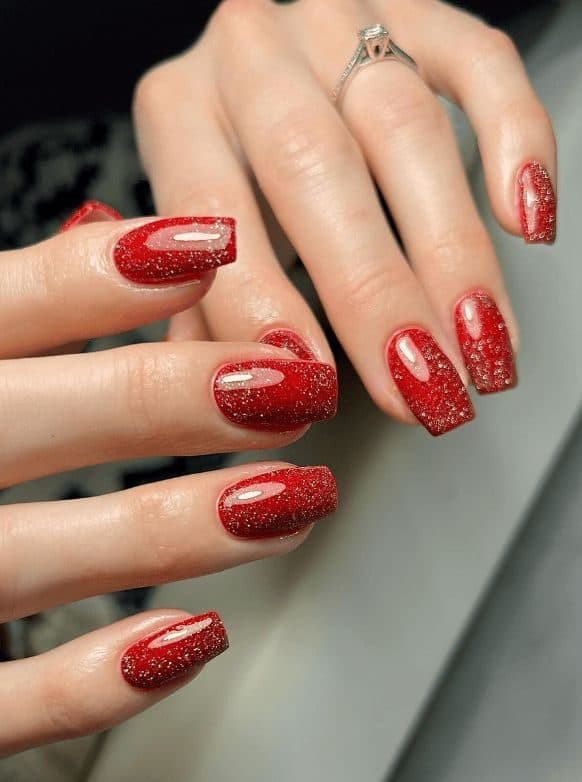 Red bridal nails with a glitter accent