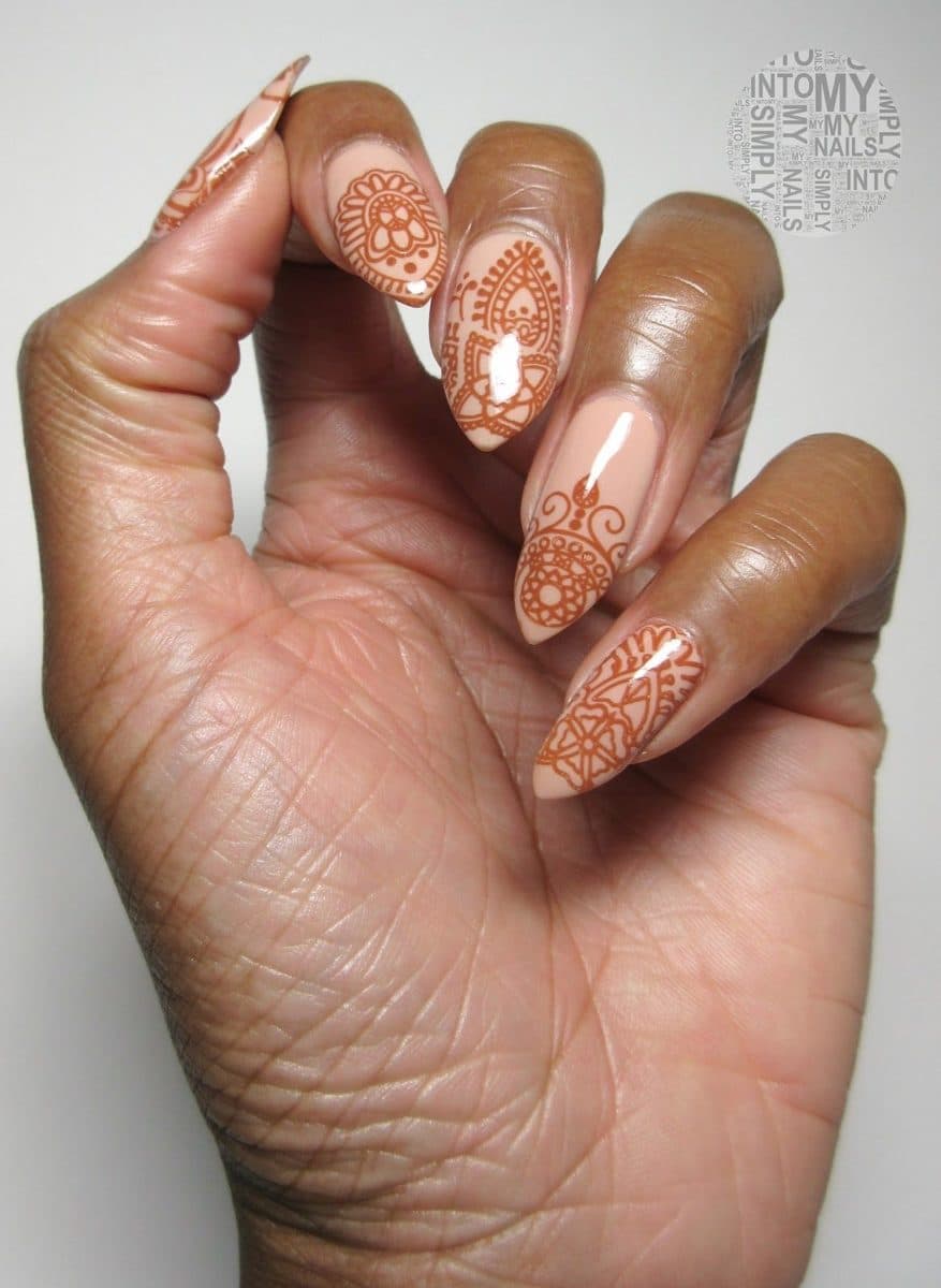 Nails painted with henna-style patterns